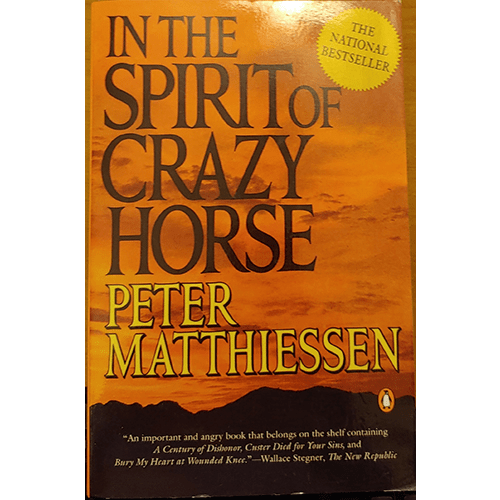 The cover of In the Spirit of Crazy Horse features a powerful image of a Native American warrior against a backdrop of the rugged Pine Ridge landscape.