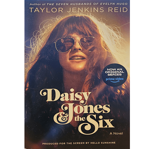 Cover of "Daisy Jones & The Six" by Taylor Jenkins Reid featuring a retro-styled image of a woman in sunglasses, with bold title typography against a backdrop of sunlit, flowing hair.