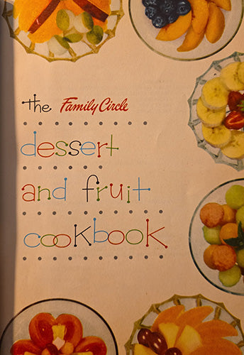 The front cover of a vintage-style cookbook titled "The Family Circle dessert and fruit cookbook," with colorful fruit illustrations around the border and the title in multicolored lettering on a warm cream background.