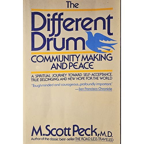 The cover of The Different Drum features bold blue and yellow text with a dove in flight. The subtitle highlights themes of community making and peace, with an endorsement from The San Francisco Chronicle.