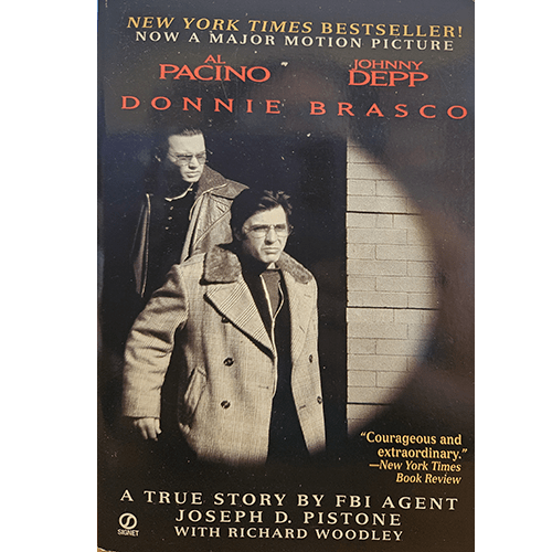 The cover of "Donnie Brasco" features Al Pacino and Johnny Depp in a scene from the movie adaptation, with a shadowy urban backdrop, emphasizing the tense, undercover nature of the true crime story.