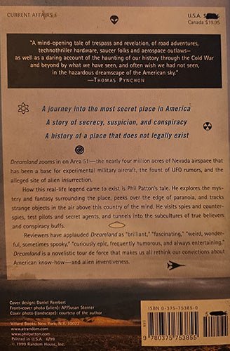 The back cover of the book 'Dreamland' by Philip Patterson, published by Random House. The cover is printed in black ink on a brown kraft-paper-like background, featuring a synopsis of the thriller story, critical acclaim, and a barcode at the bottom.