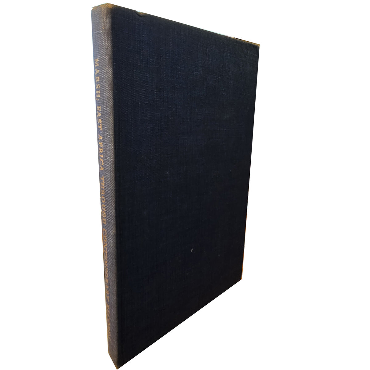 A hardcover book with a dark charcoal gray textured cover, standing upright on a light gray marble surface.
