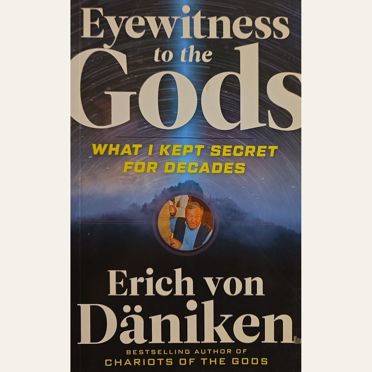 Book cover of 'Eyewitness to the Gods' by Erich von Däniken, featuring a dark blue and black background with large beige title text and yellow subtitle text.