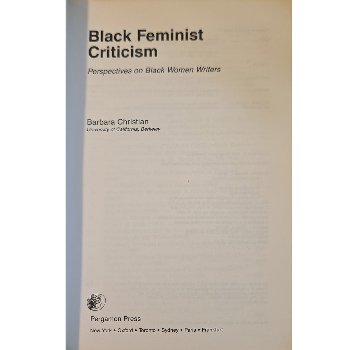 half title for 'Black Feminist Criticism: Perspectives on Black Women Writers' by Barbara Christian, published by Pergamon Press. The cover is a warm off-white/cream color with black text, featuring a vertical gray-blue spine band on the left side.