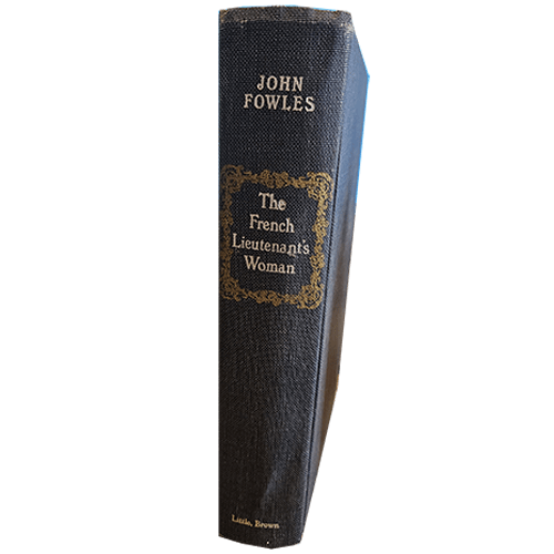 Hardcover of The French Lieutenant's Woman by John Fowles, featuring a dark blue spine with gold decorative framing around the title. Published by Little, Brown, with a classic vintage feel.