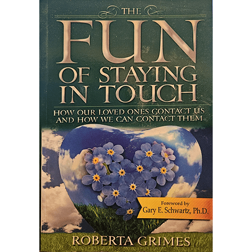 The book cover of "The Fun of Staying in Touch" features a heart-shaped arrangement of purple flowers against a cloudy sky, symbolizing the connection between the earthly and spiritual realms.