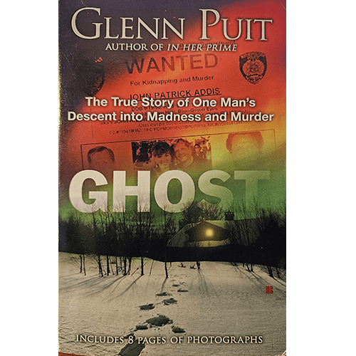 Cover of Ghost by Glenn Puit, showing a snowy scene at night with footprints, an ominous glow, and a “Wanted” notice for John Patrick Addis. Tagline: “The True Story of One Man's Descent into Madness.”