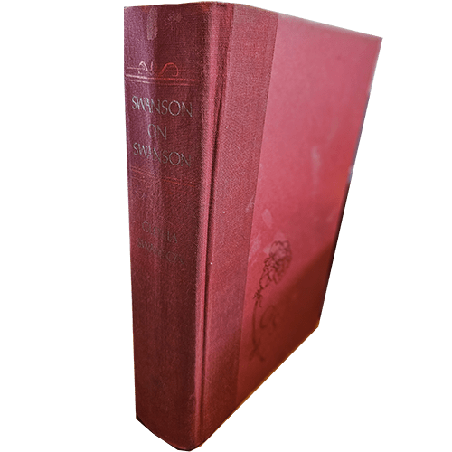 Front cover of Swanson on Swanson by Gloria Swanson, featuring a burgundy cloth binding with embossed floral detailing. The title and author’s name are embossed in silver along the spine. First edition.