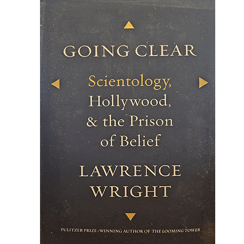 The cover of "Going Clear" by Lawrence Wright is minimalist, with gold lettering on a dark background. The title is prominent, with the subtitle and author’s name in smaller text below, framed by simple triangular designs.