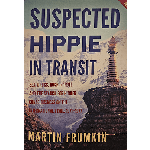 Book cover of "Suspected Hippie in Transit" by Martin Frumkin, featuring a mountain landscape with a Buddhist stupa. The title in bold text captures the essence of a 1970s journey of self-discovery and counterculture.