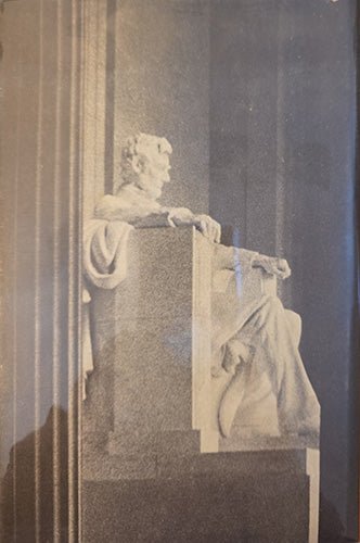 Back cover of Lincoln of all ages with Statue oLincoln in a classical setting with columns