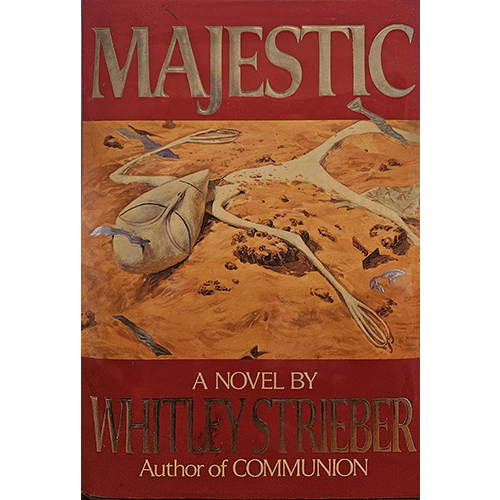 Cover of "Majestic" by Whitley Strieber features a desert-like scene with a mysterious, mask-like alien artifact partially buried in sand, surrounded by scattered debris under a bold title in red and gold.