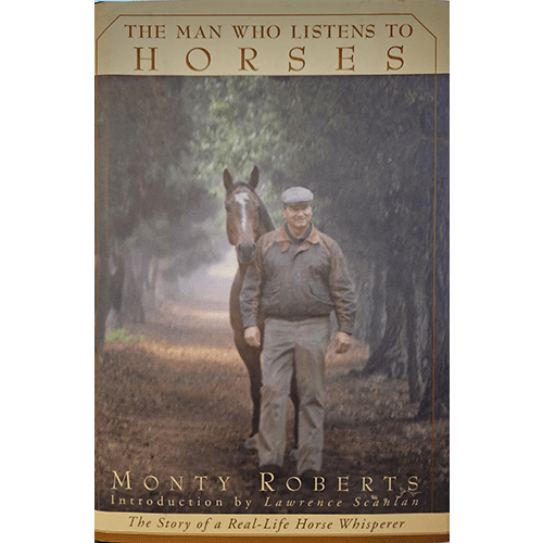  Cover of The Man Who Listens to Horses by Monty Roberts, featuring Roberts walking beside a horse down a misty tree-lined path, symbolizing his gentle approach to training and connection with horses.