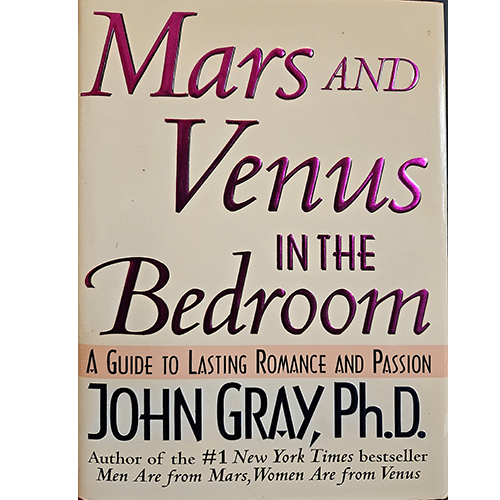 The cover of Mars and Venus in the Bedroom by John Gray features large, bold purple and pink text with a beige background, offering guidance on lasting romance, passion, and relationship intimacy.