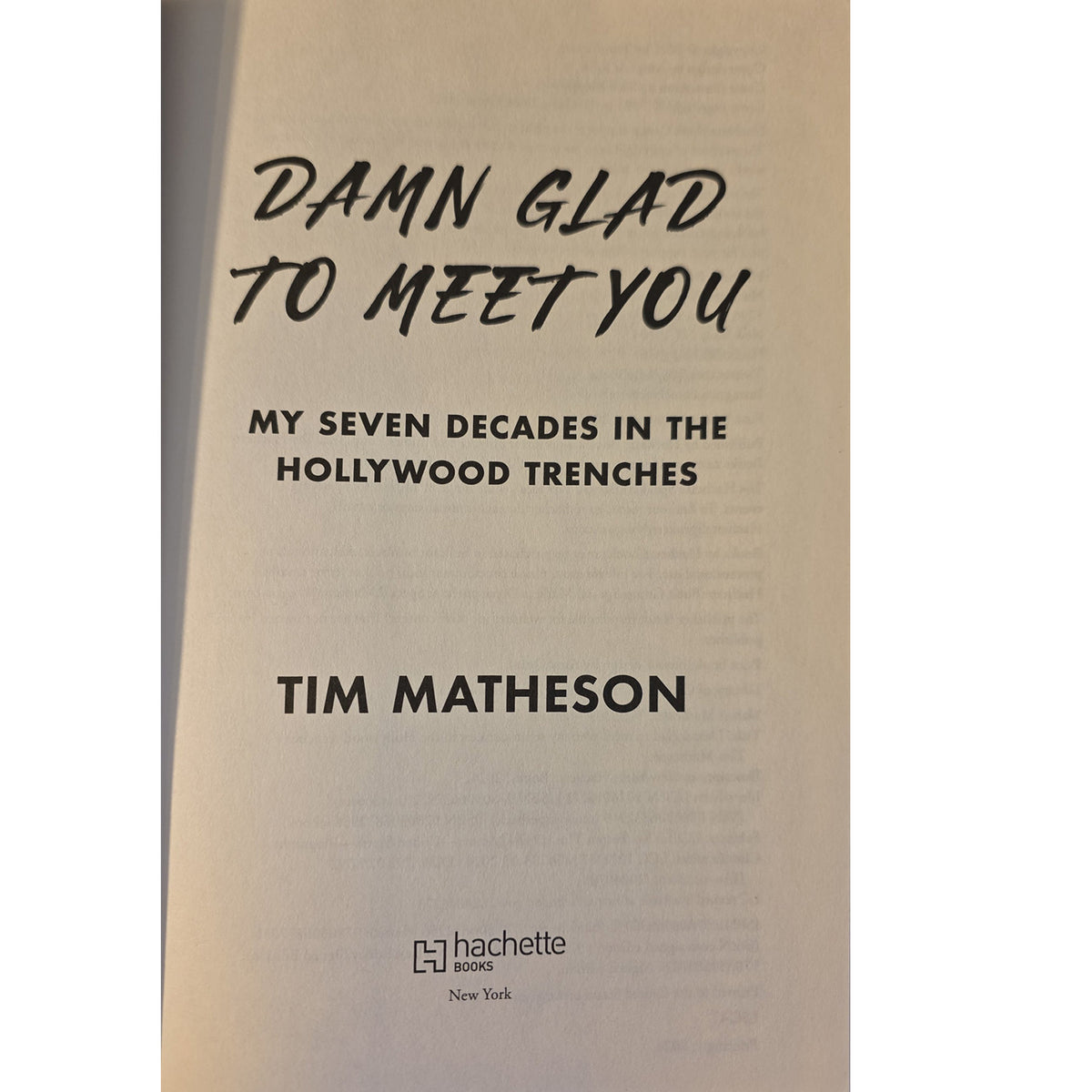 Book cover of 'Damn Glad to Meet You: My Seven Decades in the Hollywood Trenches' by Tim Matheson, published by Hachette Books. The cover features a warm beige background with black text.