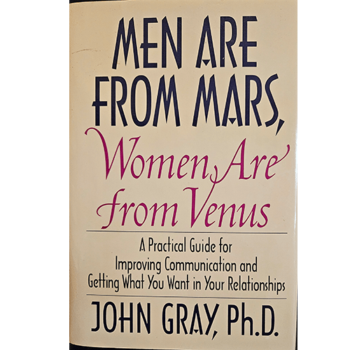 The cover of Men Are from Mars, Women Are from Venus by John Gray, Ph.D., shows the title in bold black and pink letters, offering a guide to improving communication and relationships between men and women.