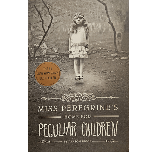 A haunting black-and-white image of a girl wearing a vintage dress and headband, standing alone in a misty forest, graces the cover of Miss Peregrine's Home for Peculiar Children by Ransom Riggs.