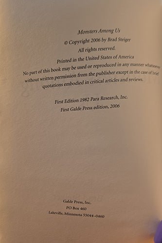 A close-up of a book's copyright page for 'Monsters Among Us' by Brad Steiger, published by Galde Press. The page is printed on warm beige paper with black text detailing copyright, publisher information, and edition details.