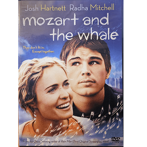 DVD cover of "Mozart and the Whale" featuring Josh Hartnett and Radha Mitchell. Both characters are shown smiling against a blue sky backdrop, with text emphasizing their connection.