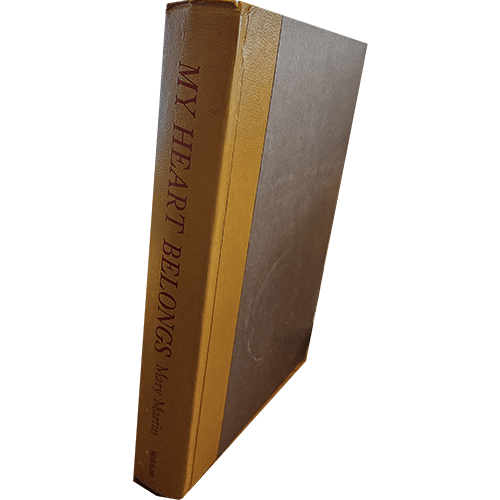 The cover of "My Heart Belongs" by Mary Martin features a vintage, hardcover design with the title embossed in gold on the spine, reflecting the classic and timeless essence of this memoir.