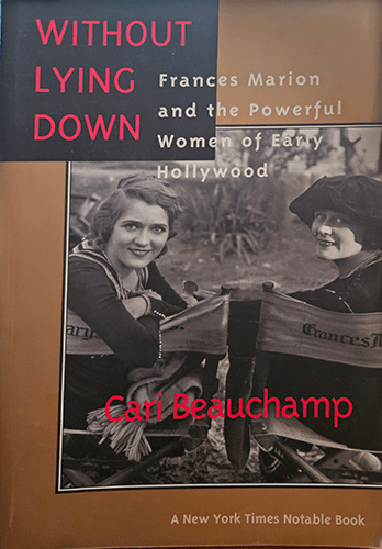 The cover of Without Lying Down by Cari Beauchamp features a vintage photo of Frances Marion and a colleague, both smiling in early Hollywood attire, framed by bold red and white text on a sepia backdrop.