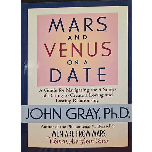 The cover of Mars and Venus on a Date features bold, large fonts in blue and red against a soft pink background. It prominently displays the title and author John Gray, Ph.D., with a clean, modern layout.