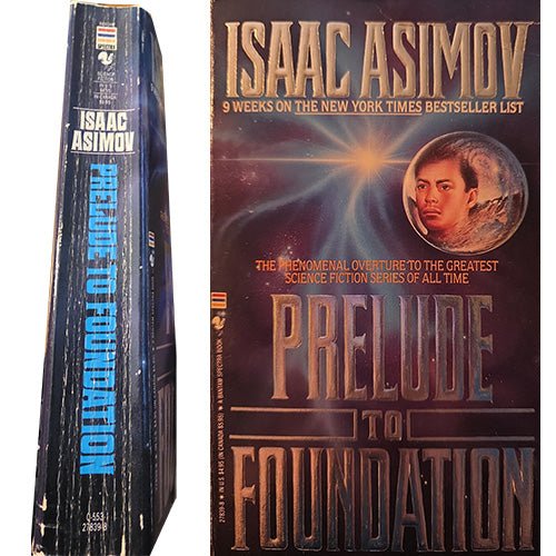 A vintage Isaac Asimov hardcover book shown standing next to its front cover. The book spine and cover feature the title 'Prelude to Foundation' in large metallic-style lettering, with Isaac Asimov's name prominently displayed at the top.