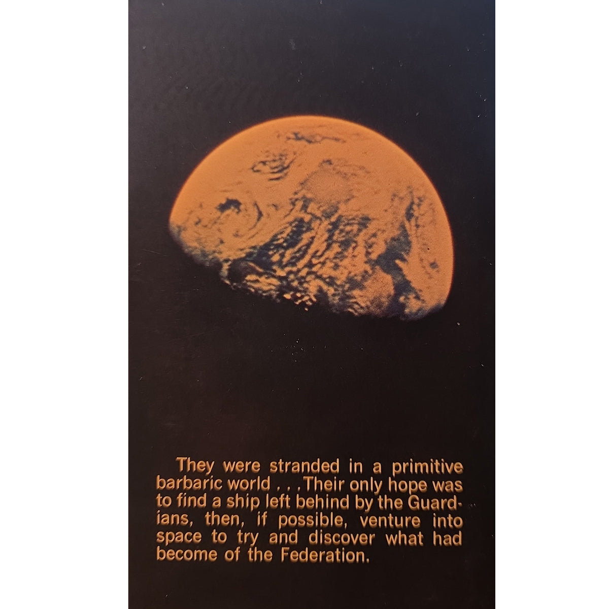 back cover featuring a large orange-toned planet or moon against a black background, with orange text at the bottom reading, 'They were stranded in a primitive barbaric world.