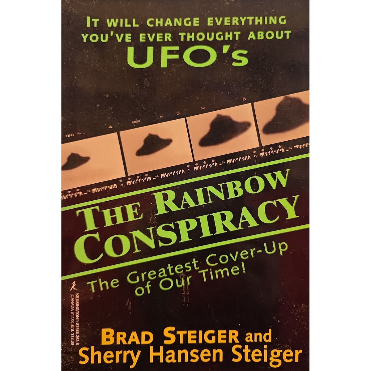 Book cover for 'The Rainbow Conspiracy' by Brad Steiger and Sherry Hansen Steiger, featuring a dark brown background with green and orange text and UFO-related imagery.