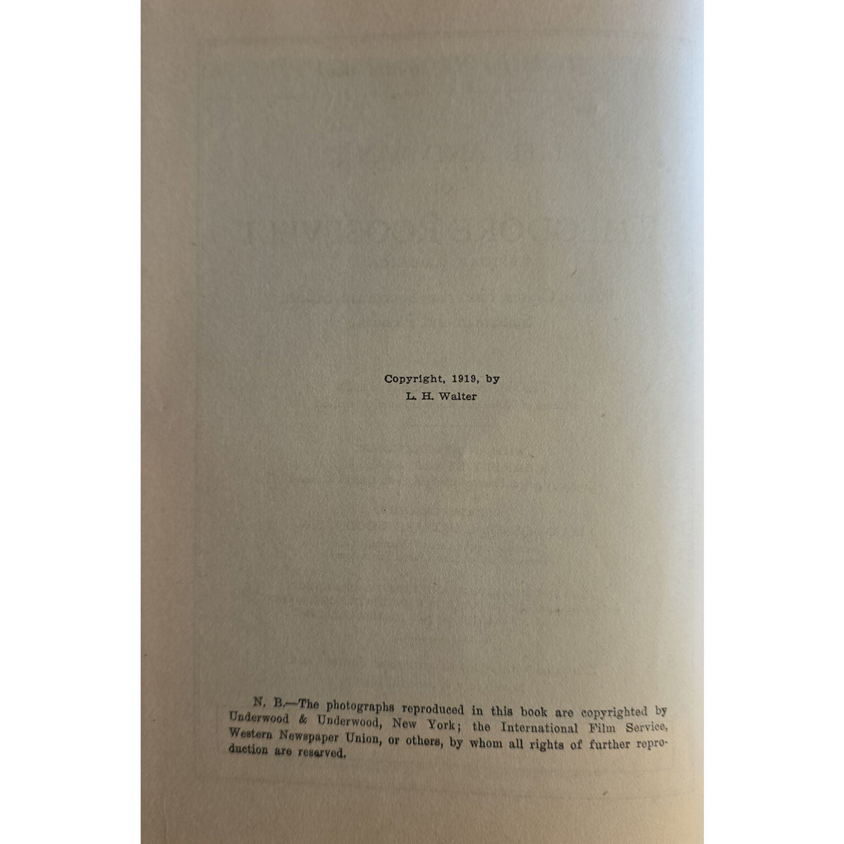 A vintage book page with a beige background, featuring a copyright notice for 'The Woodlands' by L. H. Walter from 1915.