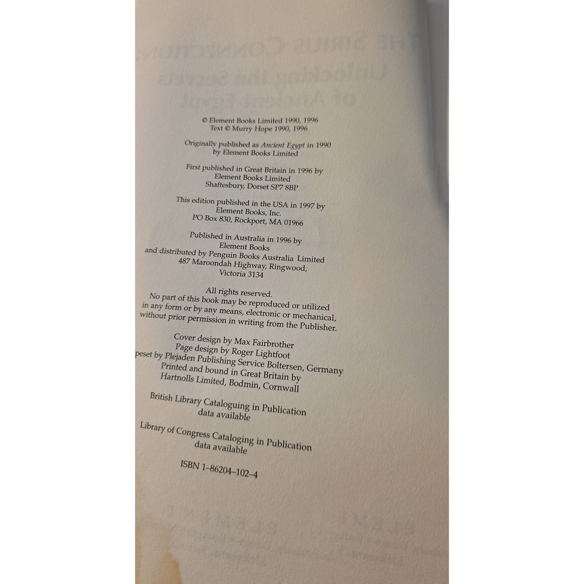 A close-up of a book's printed copyright page showing publication details and ISBN 1-86294-102-4 on aged beige paper.