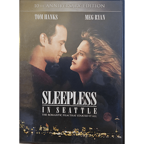 The cover of the 10th Anniversary Edition DVD of Sleepless in Seattle, featuring Tom Hanks and Meg Ryan looking at each other against a Seattle skyline, highlighting the romance and allure of this classic.