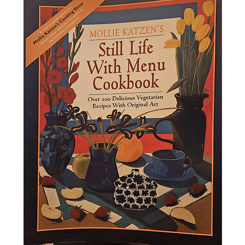 Cover of Still Life With Menu Cookbook by Mollie Katzen, showing vibrant artwork of kitchenware and flowers. The cover highlights over 200 vegetarian recipes paired with Katzen's original art.