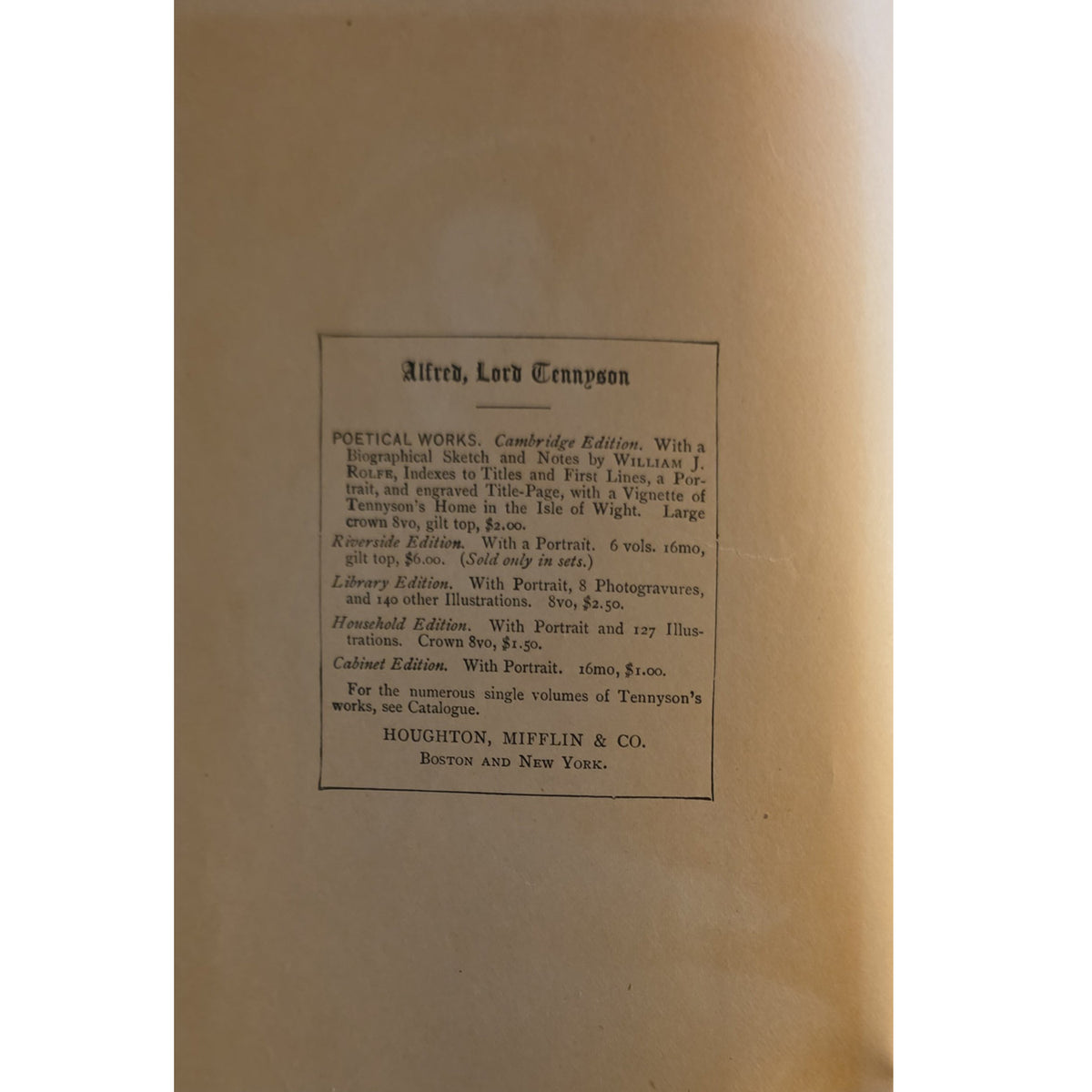 A close-up of a vintage book's inner cover or title page, showing printed text on warm tan paper with a black border and a central black rectangular label.