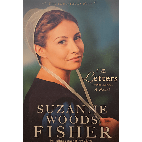 The cover features a serene Amish woman, Rose Schrock, dressed in traditional attire, gazing thoughtfully into the distance, symbolizing the quiet strength and faith central to "The Letters" by Suzanne Woods Fisher.