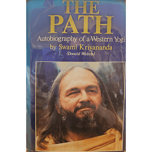 Cover of The Path: Autobiography of a Western Yogi by Swami Kriyananda, featuring a serene portrait of the author with long hair and a beard, dressed in traditional spiritual attire against a blue background.