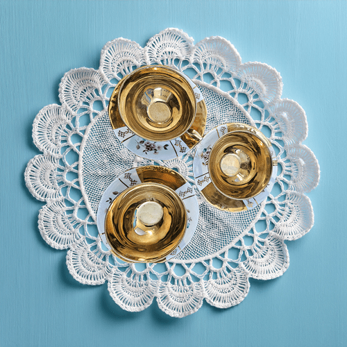three demitasse cups on white doily