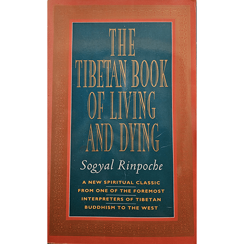 Cover of The Tibetan Book of Living and Dying by Sogyal Rinpoche. Features a dark green center with golden text, bordered by a red frame, displaying intricate golden patterns along the edges.