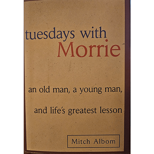 First edition cover of Tuesdays with Morrie by Mitch Albom, featuring a minimalist design with the subtitle, “An old man, a young man, and life’s greatest lesson,” in pristine Brodart protection.