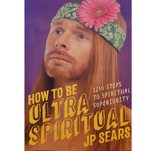 A humorous cover featuring JP Sears with long red hair, a green headband with a pink flower, and a contemplative expression. The title reads "How to Be Ultra Spiritual: 12½ Steps to Spiritual Superiority.