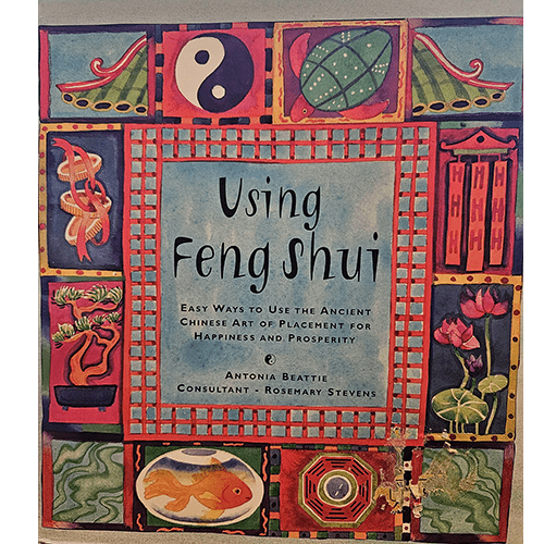 The cover of "Using Feng Shui" features vibrant, symbolic art including yin-yang, koi fish, and lotus flowers, framed by colorful traditional patterns, reflecting the book's focus on harmony and prosperity.