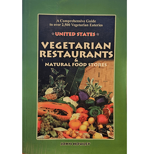 Cover of "United States Vegetarian Restaurants & Natural Food Stores" by John Howley, featuring a green border with a central image of assorted vegetables and fruits, and bold white text on a dark background. The subtitle reads "A Comprehensive Guide to over 2,500 Vegetarian Eateries."