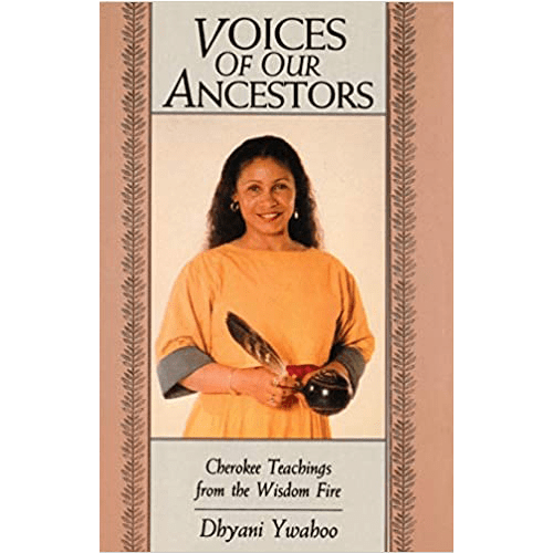 Cover of Voices of Our Ancestors: Cherokee Teachings from the Wisdom Fire by Dhyani Ywahoo, featuring the author in a yellow top holding a feather and a ceremonial object against a peach background.