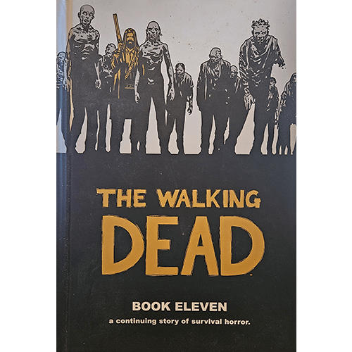 Black-and-white comic-style cover featuring a horde of zombies with one armed survivor in gold. The title The Walking Dead is embossed in bold gold letters.