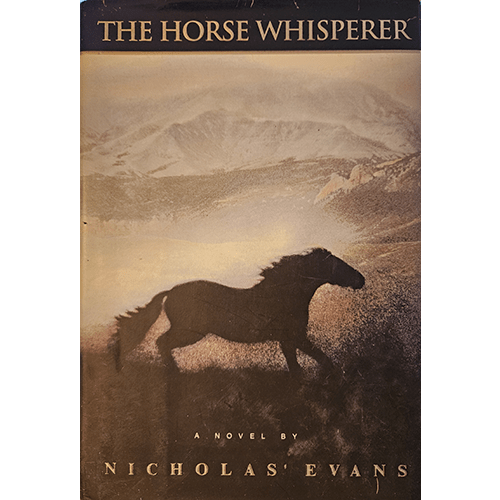 Cover of The Horse Whisperer by Nicholas Evans shows a silhouette of a galloping horse set against a serene, mountainous landscape. The muted tones evoke the novel's themes of healing and redemption.